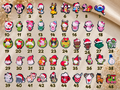 Numbered grid of forty eight Christmas shoe charms featuring cartoon characters and holiday icons