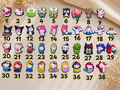Collection of thirty eight numbered Kitty shoe charms featuring various cartoon characters