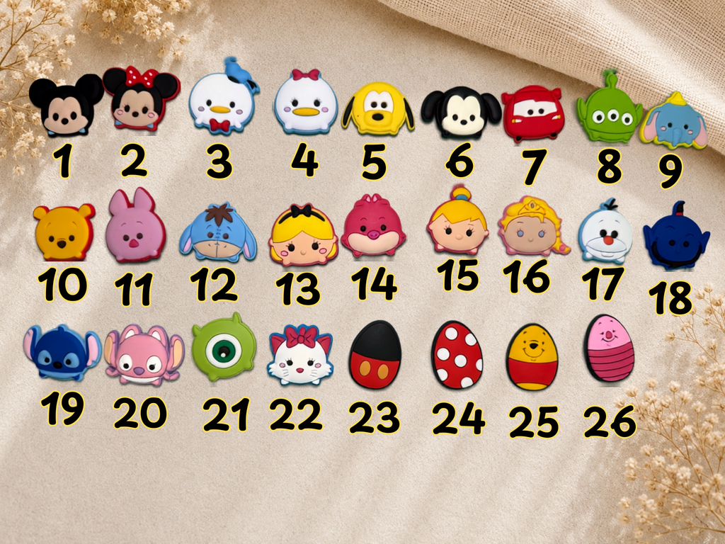 Numbered grid of twenty six Sum Sum shoe charms featuring various cartoon character designs