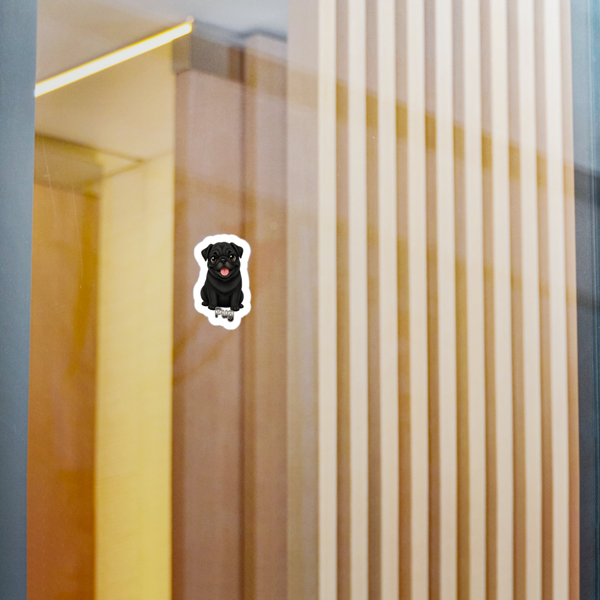 A small die-cut sticker of a black dog with a red tongue, shown on a glass door or window with a modern interior background of vertical wooden slats.