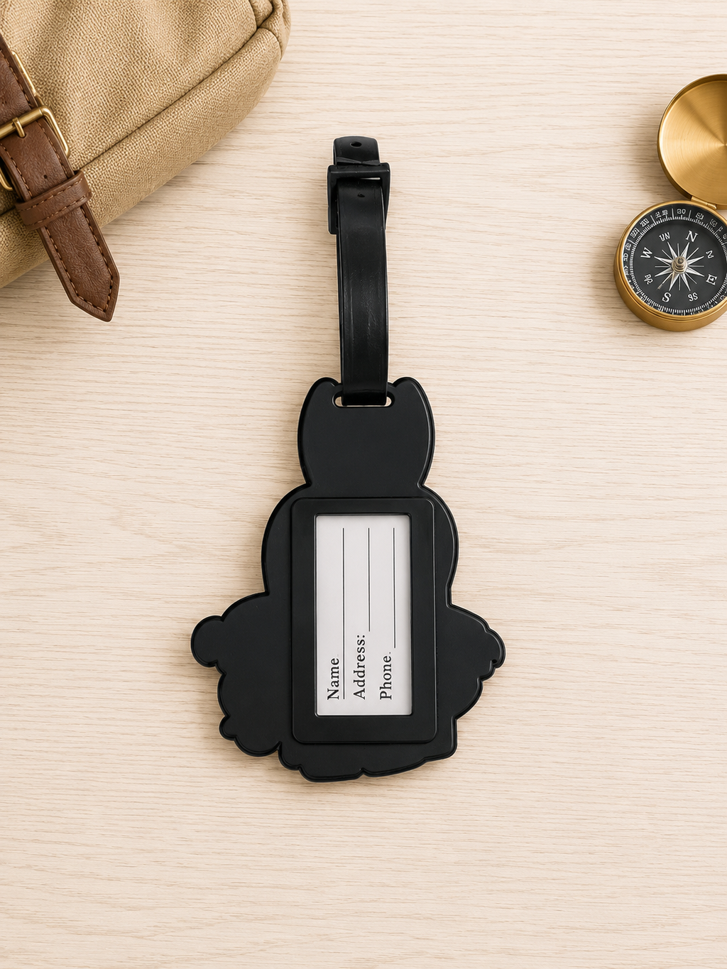Wizard School luggage tag with blank contact information card on a wooden surface