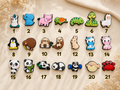 Numbered grid of twenty one assorted animal shoe charms