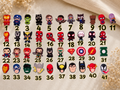 Numbered grid of Superheroes Shoe Charms featuring various comic book characters and logos