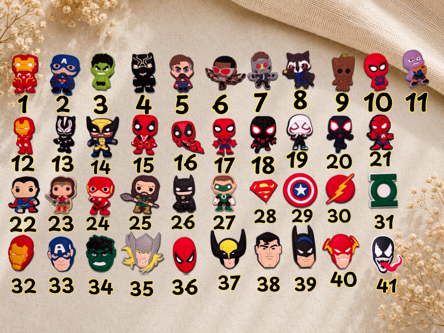 Numbered grid of Superheroes Shoe Charms featuring various comic book characters and logos